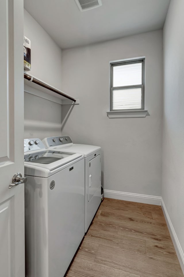 237 Gardenia Dr, Azle, TX 76020 - laundry room featuring independent washer and dryer and light wood-type flooring