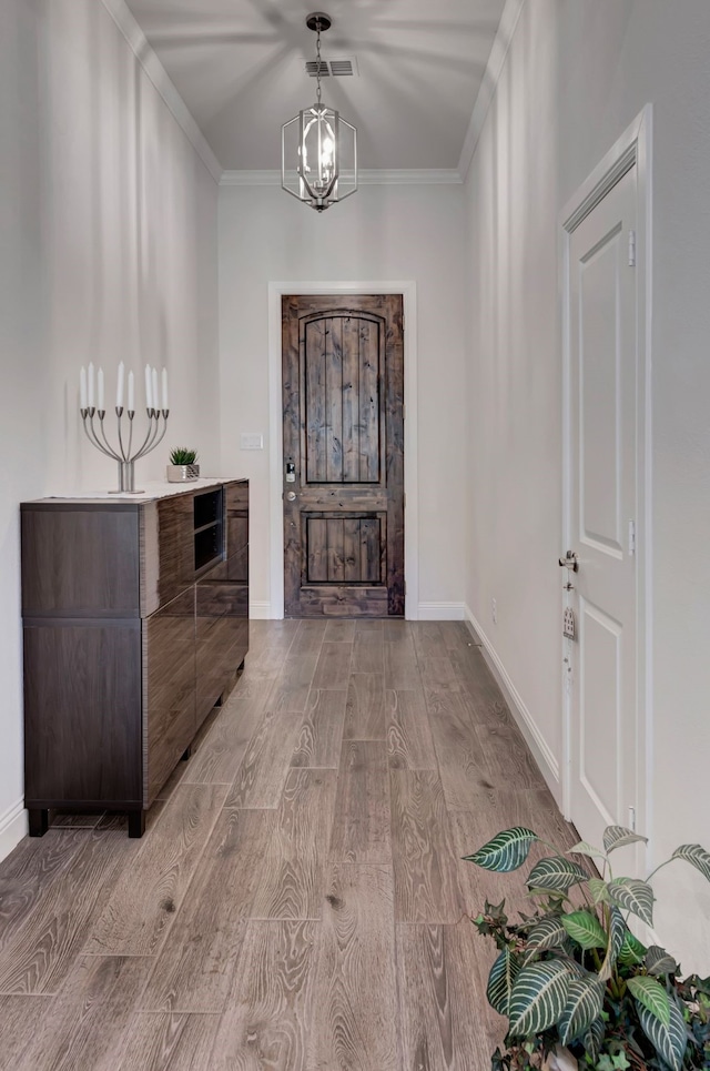 237 Gardenia Dr, Azle, TX 76020 - foyer entrance with light wood-type flooring, ornamental molding, and a chandelier
