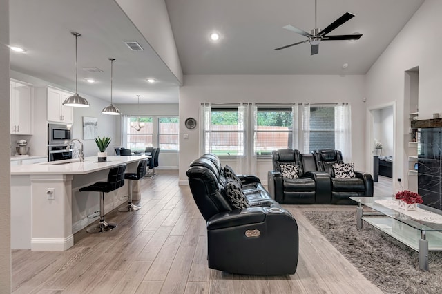 237 Gardenia Dr, Azle, TX 76020 - living room featuring a ceiling fan, light wood-type flooring, high vaulted ceiling, and recessed lighting