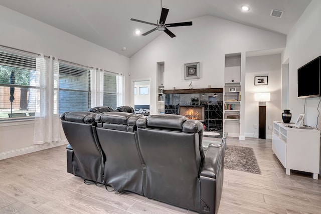 237 Gardenia Dr, Azle, TX 76020 - home theater room featuring a ceiling fan, light wood-type flooring, a fireplace, recessed lighting, and high vaulted ceiling