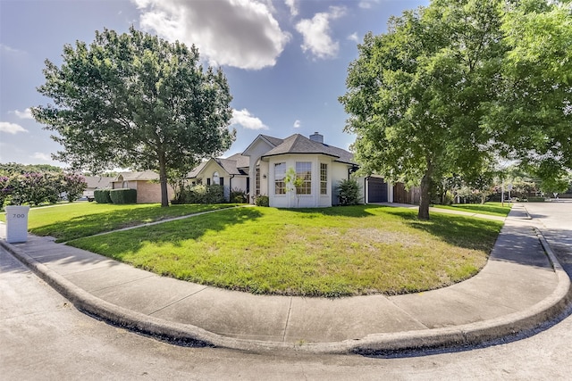 700 Stanford Dr, Waxahachie, TX 75165 - view of front facade with an attached garage, a front yard, stucco siding, and a chimney