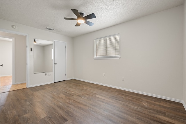 721 SW Hillside Dr, Burleson, TX 76028 - unfurnished bedroom with wood finished floors, a textured ceiling, and a ceiling fan