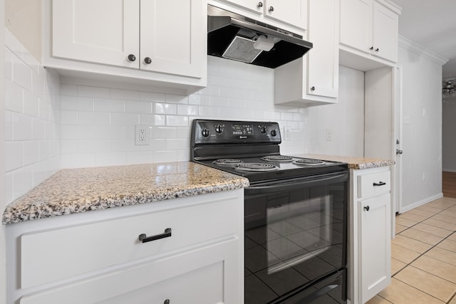 721 SW Hillside Dr, Burleson, TX 76028 - kitchen featuring black electric range oven, under cabinet range hood, white cabinets, light stone counters, and decorative backsplash