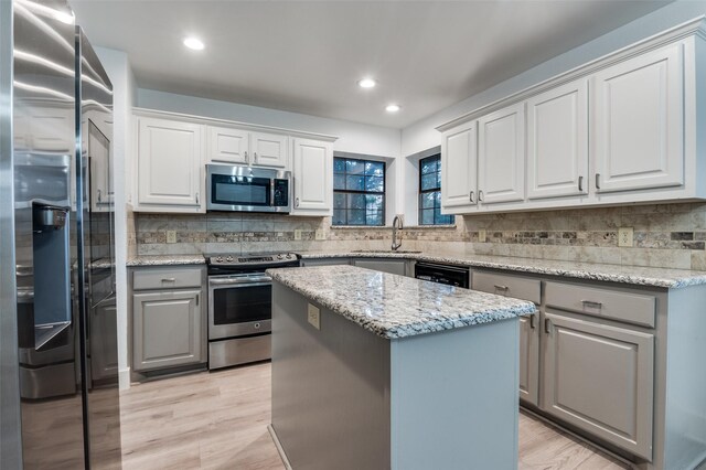 4030 Walnut Ln, Midlothian, TX 76065 - kitchen featuring appliances with stainless steel finishes, gray cabinets, tasteful backsplash, a kitchen island, and recessed lighting