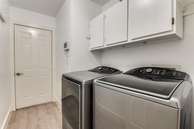 4030 Walnut Ln, Midlothian, TX 76065 - laundry area featuring cabinet space, light wood-type flooring, and washing machine and clothes dryer
