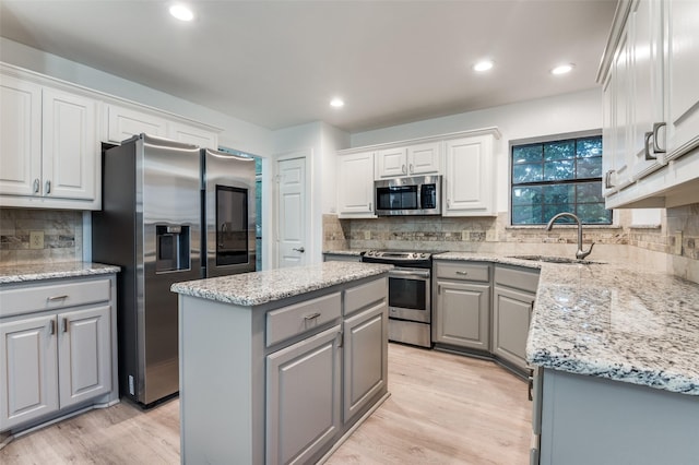 4030 Walnut Ln, Midlothian, TX 76065 - kitchen featuring gray cabinets, appliances with stainless steel finishes, light wood finished floors, decorative backsplash, and recessed lighting
