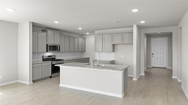 1327 Burgess St, Royse City, TX 75189 - kitchen featuring stainless steel appliances, gray cabinets, recessed lighting, backsplash, and a center island with sink
