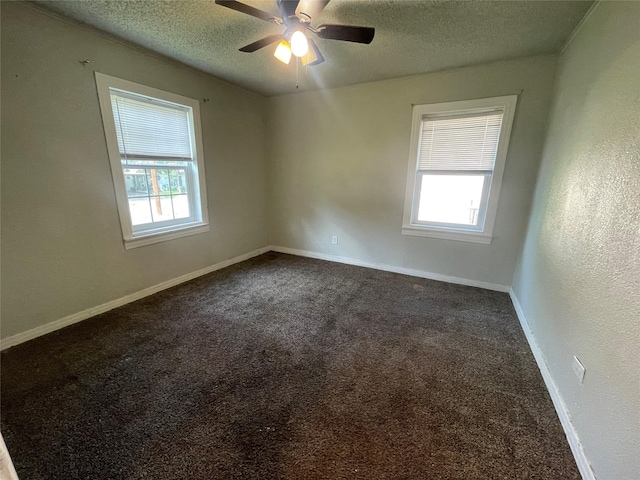 207 Whitworth St, Sulphur Springs, TX 75482 - empty room with healthy amount of natural light, a textured ceiling, a ceiling fan, and dark colored carpet