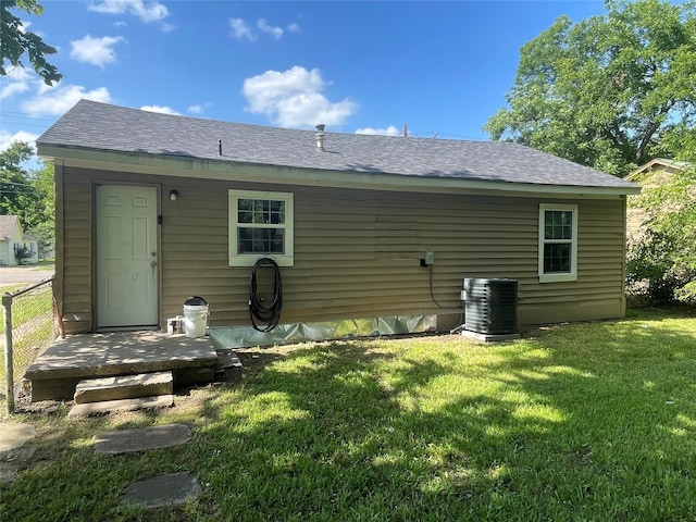 207 Whitworth St, Sulphur Springs, TX 75482 - rear view of property featuring a lawn and roof with shingles