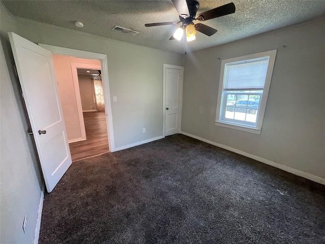 207 Whitworth St, Sulphur Springs, TX 75482 - unfurnished bedroom with carpet floors, a textured ceiling, and ceiling fan