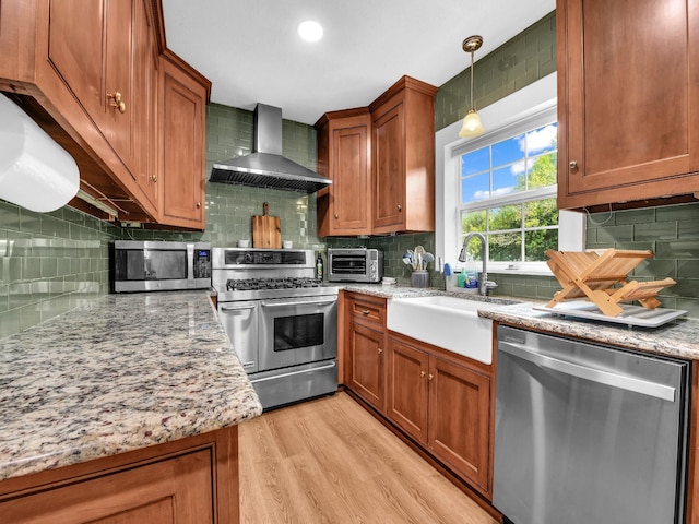 3921 Bryce Ave, Fort Worth, TX 76107 - kitchen with wall chimney range hood, appliances with stainless steel finishes, decorative backsplash, and brown cabinetry