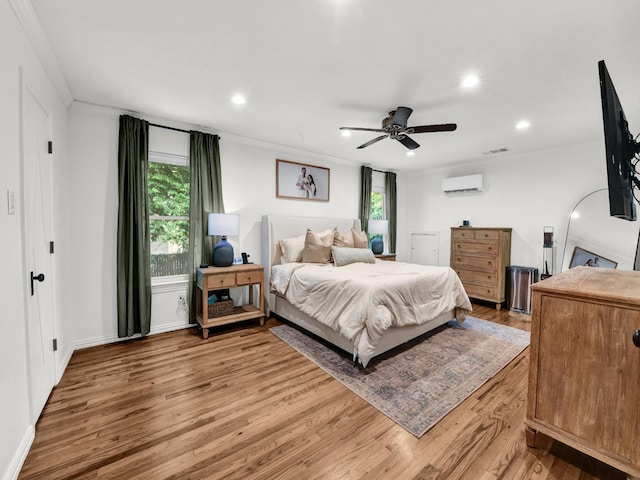 3921 Bryce Ave, Fort Worth, TX 76107 - bedroom featuring a wall mounted air conditioner, multiple windows, wood finished floors, ornamental molding, and recessed lighting