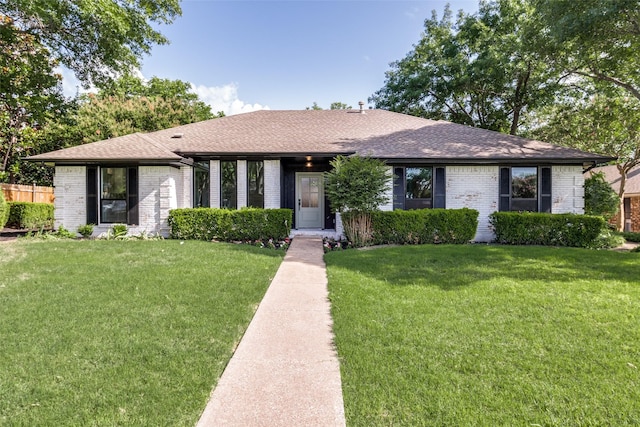 707 Lake Meadows Dr, Rockwall, TX 75087 - ranch-style home with brick siding, a front yard, and a shingled roof