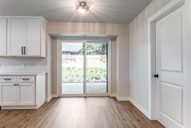 707 Lake Meadows Dr, Rockwall, TX 75087 - unfurnished dining area with baseboards and light wood-style flooring