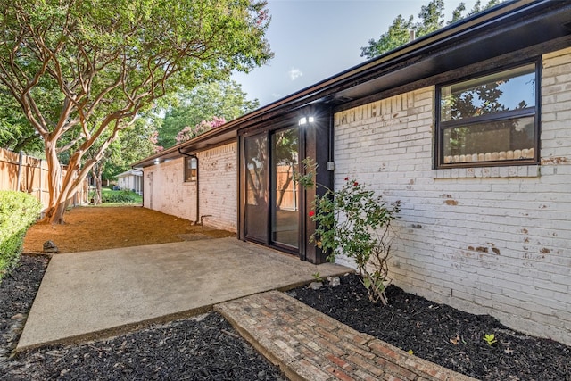 707 Lake Meadows Dr, Rockwall, TX 75087 - view of exterior entry with a patio and brick siding