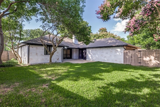 707 Lake Meadows Dr, Rockwall, TX 75087 - rear view of house featuring brick siding, a patio, and a chimney