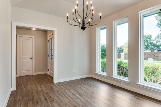 707 Lake Meadows Dr, Rockwall, TX 75087 - empty room featuring wood finished floors, a chandelier, and plenty of natural light