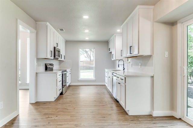 707 Lake Meadows Dr, Rockwall, TX 75087 - kitchen featuring stainless steel appliances, light countertops, light wood finished floors, recessed lighting, and backsplash