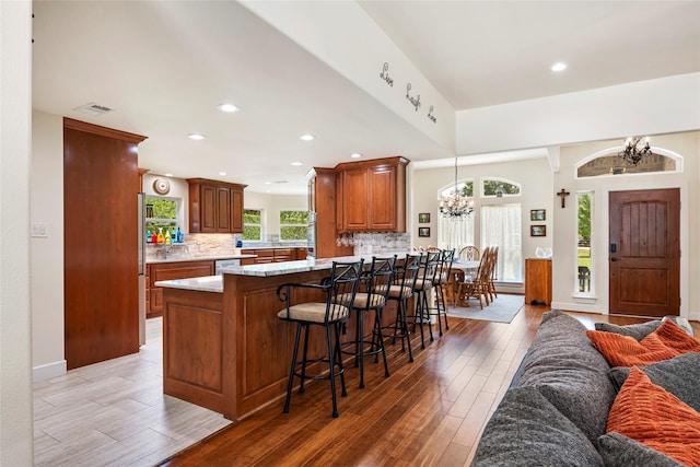 750 Emerald Sound Blvd, Oak Point, TX 75068 - kitchen featuring a chandelier, decorative backsplash, light wood-style flooring, and recessed lighting