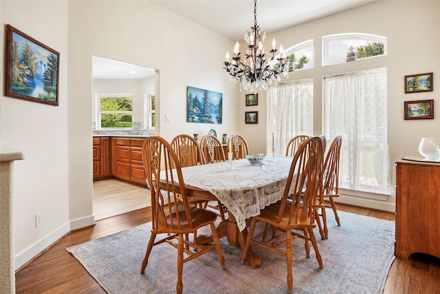 750 Emerald Sound Blvd, Oak Point, TX 75068 - dining space with a chandelier, light wood-style floors, and a towering ceiling