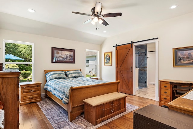 750 Emerald Sound Blvd, Oak Point, TX 75068 - bedroom featuring a barn door, light wood-type flooring, recessed lighting, ceiling fan, and lofted ceiling