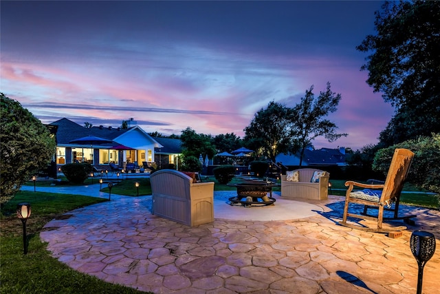 750 Emerald Sound Blvd, Oak Point, TX 75068 - patio terrace at dusk with a patio area, a fire pit, and a lawn