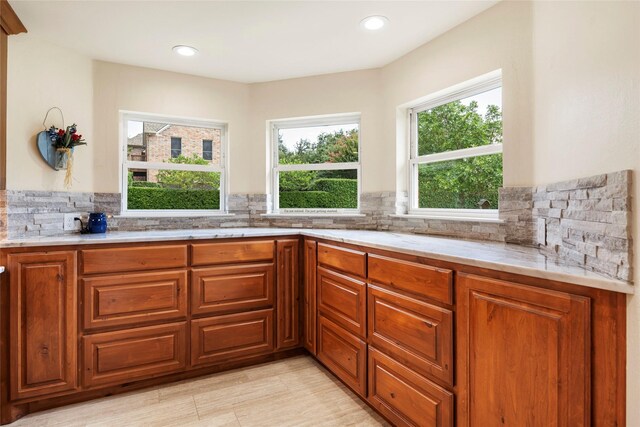 750 Emerald Sound Blvd, Oak Point, TX 75068 - kitchen featuring brown cabinetry, tasteful backsplash, light countertops, and recessed lighting