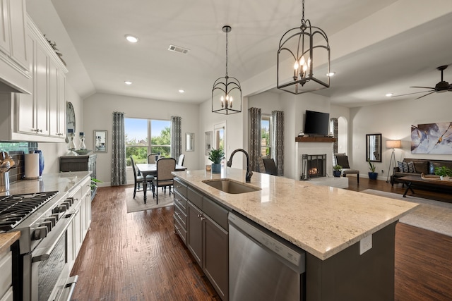 1105 Denton Creek Dr, Justin, TX 76247 - kitchen featuring stainless steel appliances, open floor plan, light stone counters, an island with sink, and recessed lighting
