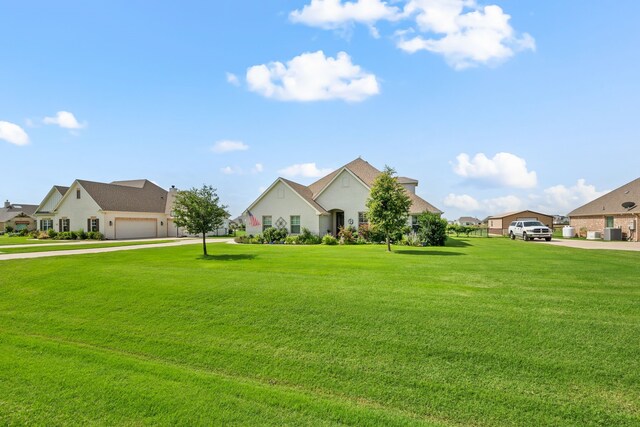 1105 Denton Creek Dr, Justin, TX 76247 - view of front of property featuring a residential view, a front yard, driveway, and stucco siding