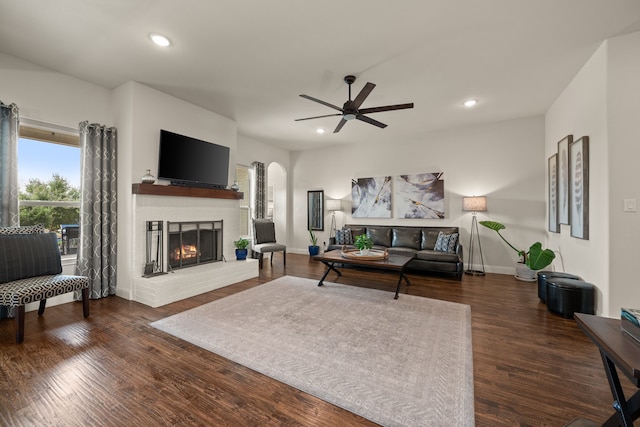 1105 Denton Creek Dr, Justin, TX 76247 - living area featuring ceiling fan, a brick fireplace, recessed lighting, dark wood-type flooring, and arched walkways