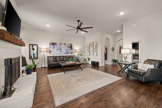 1105 Denton Creek Dr, Justin, TX 76247 - living area featuring arched walkways, a fireplace, ceiling fan, recessed lighting, and wood finished floors
