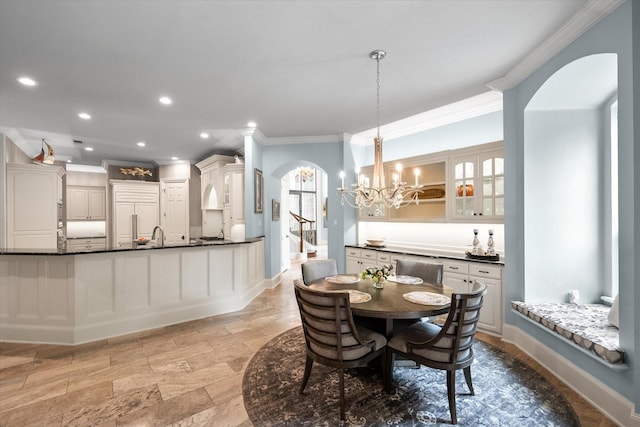 5106 Oak Ln, Arlington, TX 76017 - dining area with ornamental molding, arched walkways, light stone finish flooring, a chandelier, and recessed lighting