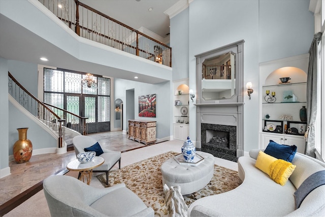 5106 Oak Ln, Arlington, TX 76017 - living area featuring a high ceiling, stairway, built in features, a chandelier, and a fireplace