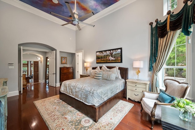 5106 Oak Ln, Arlington, TX 76017 - bedroom featuring a towering ceiling, arched walkways, dark wood finished floors, and ornamental molding