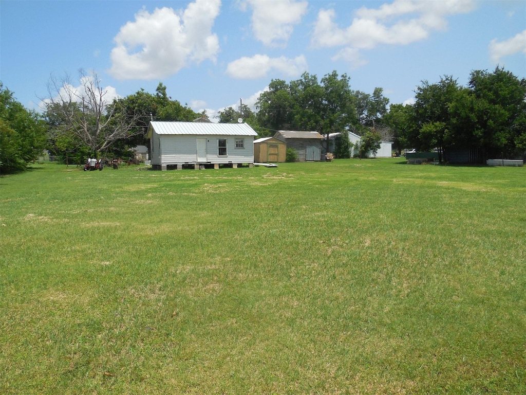 307 Travis St, Ranger, TX 76470 - view of grassy yard with a storage unit