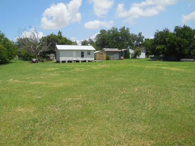 307 Travis St, Ranger, TX 76470 - view of grassy yard with a storage unit