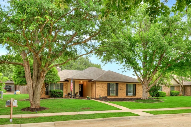 1665 N Valley Pkwy, Lewisville, TX 75077 - ranch-style house featuring brick siding, a front yard, a chimney, and roof with shingles