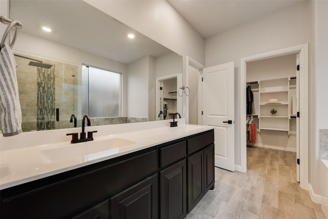 1424 Archway Ct, Fort Worth, TX 76247 - full bath with a stall shower, a walk in closet, double vanity, wood finished floors, and recessed lighting