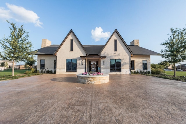 1424 Archway Ct, Fort Worth, TX 76247 - view of front facade with a chimney, brick siding, and a shingled roof