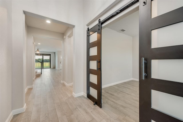1424 Archway Ct, Fort Worth, TX 76247 - hallway featuring a barn door, light wood-style floors, and recessed lighting
