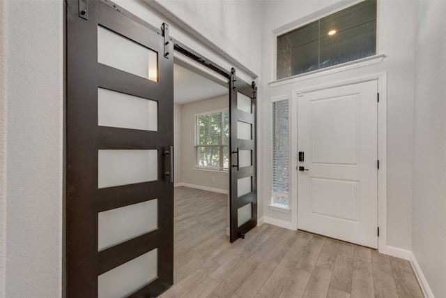 1424 Archway Ct, Fort Worth, TX 76247 - foyer entrance featuring a barn door and light wood finished floors