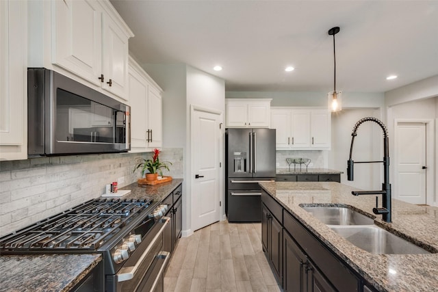 1424 Archway Ct, Fort Worth, TX 76247 - kitchen featuring stainless steel appliances, white cabinets, hanging light fixtures, dark stone counters, and recessed lighting