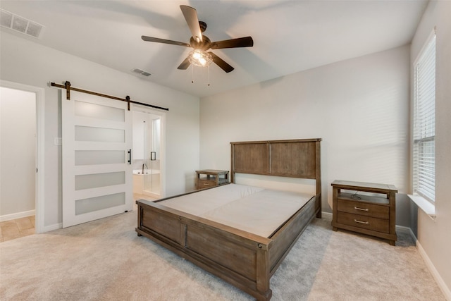 1424 Archway Ct, Fort Worth, TX 76247 - bedroom featuring a barn door, light carpet, ensuite bath, and ceiling fan