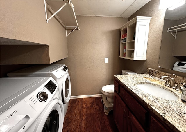18240 Midway Rd Unit 902, Dallas, TX 75287 - laundry room with washer and dryer, dark wood-style floors, and a textured wall