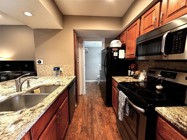 18240 Midway Rd Unit 902, Dallas, TX 75287 - kitchen with appliances with stainless steel finishes, dark wood-style flooring, backsplash, and light stone countertops