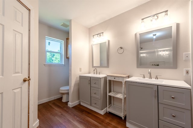 103 Irvin Ln, Mount Vernon, TX 75457 - bathroom featuring two vanities, wood finished floors, and a shower