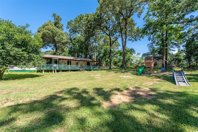 103 Irvin Ln, Mount Vernon, TX 75457 - view of green lawn featuring a playground and a porch