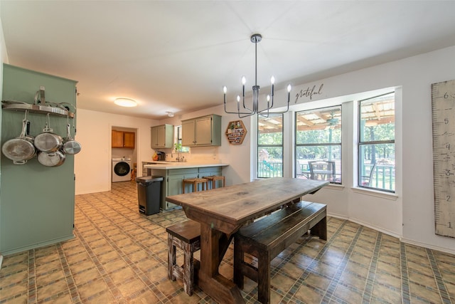 103 Irvin Ln, Mount Vernon, TX 75457 - dining area featuring washer / dryer, a chandelier, and light flooring
