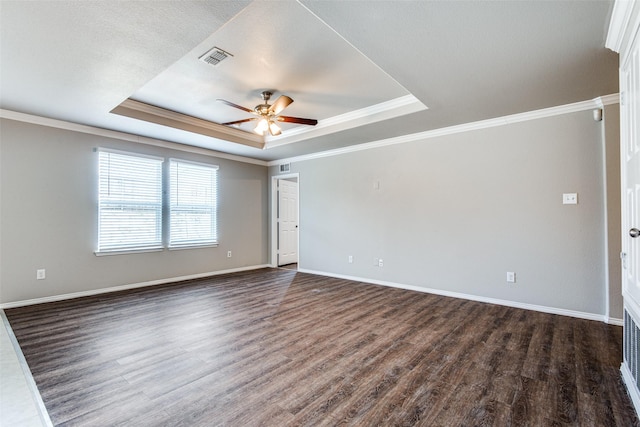 3109 Layla Creek Dr, Little Elm, TX 75068 - spare room featuring a tray ceiling, dark wood finished floors, ceiling fan, and crown molding