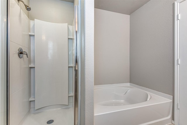 3109 Layla Creek Dr, Little Elm, TX 75068 - full bathroom featuring a shower stall, a garden tub, and a textured wall